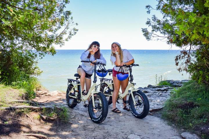 a person riding a bike down a dirt road