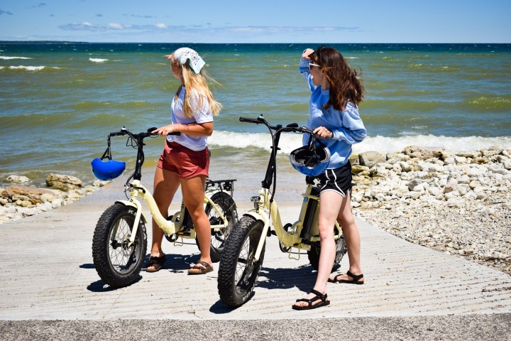 a couple of people on a beach near a body of water