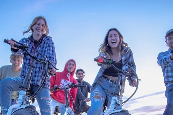 a group of people riding on the back of a motorcycle