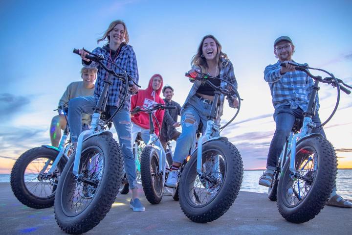 a group of people riding on the back of a motorcycle